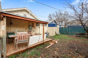 Back of house with central AC unit