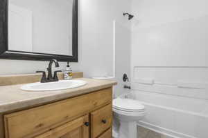 Full bathroom with vanity, toilet, and tub / shower combination