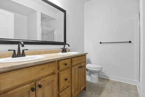 Bathroom featuring vanity, toilet, and walk in shower