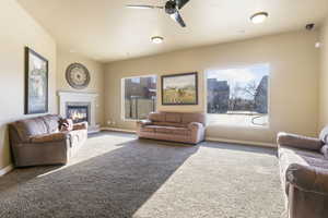 Living room with ceiling fan and carpet