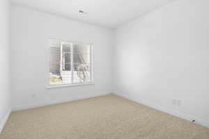 View of carpeted spare room