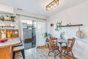 Dining area featuring light wood-type flooring and a textured ceiling