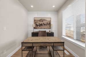 Home office featuring recessed lighting, wood finished floors, visible vents, and baseboards