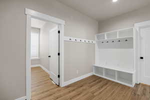 Mudroom with baseboards and wood finished floors