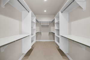 Spacious closet with light colored carpet