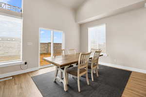 Dining area featuring visible vents, baseboards, and wood finished floors