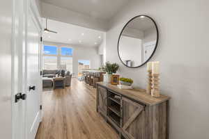 Hall with light wood-type flooring and recessed lighting