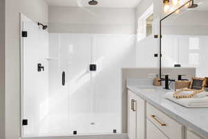 Bathroom with a stall shower and vanity