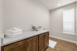 Interior space with light wood-style floors, baseboards, and recessed lighting