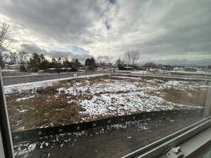 View of yard covered in snow