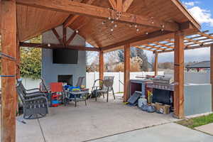 View of patio featuring a fireplace