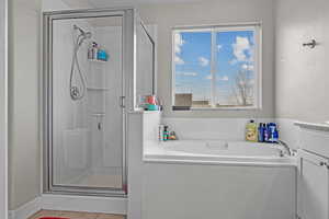 Bathroom with vanity, tile patterned flooring, and independent shower and bath