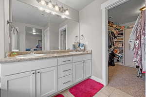 Bathroom featuring a textured ceiling, tile patterned floors, and vanity