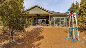 Rear view of property featuring ceiling fan