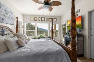 Bedroom with ceiling fan and access to outside