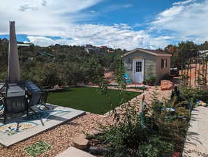 View of yard featuring an outbuilding and a patio