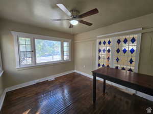 Office area featuring dark hardwood / wood-style floors and ceiling fan