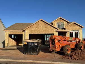 Unfinished property featuring a garage