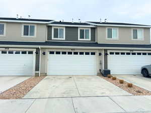 Front of property featuring a garage and central AC