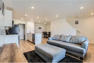 Living room with sink and light hardwood / wood-style floors