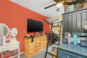 Carpeted bedroom with ceiling fan