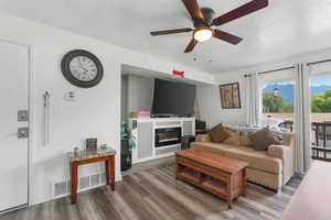 Living room with ceiling fan and wood-type flooring