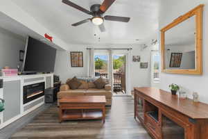 Living room featuring dark hardwood / wood-style floors and ceiling fan