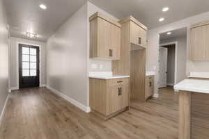 Kitchen featuring light brown cabinets and light hardwood / wood-style flooring