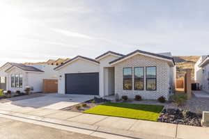 View of front facade with a garage and cooling unit