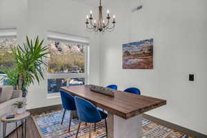 Home office featuring hardwood / wood-style floors and a chandelier