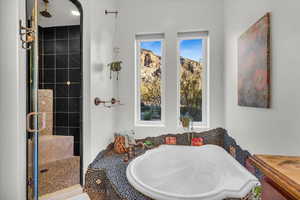 Bathroom featuring shower with separate bathtub