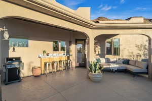 View of patio / terrace with an outdoor living space, an outdoor bar, and grilling area