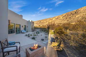 View of patio featuring a mountain view and a fire pit