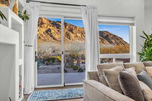 Doorway to outside featuring a mountain view and hardwood / wood-style flooring