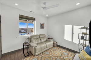 Living room with light wood-type flooring and ceiling fan