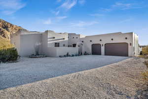 Pueblo-style home with a garage