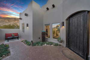 Exterior entry at dusk featuring a patio