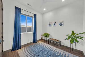 Living area with ceiling fan and hardwood / wood-style flooring