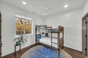 Bedroom featuring dark hardwood / wood-style flooring and ceiling fan