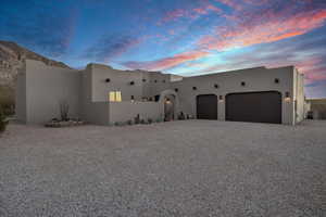 Pueblo-style home with a garage