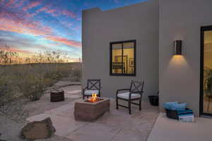 Patio terrace at dusk featuring a fire pit