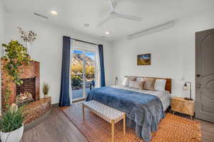 Bedroom with light wood-type flooring, access to outside, and ceiling fan