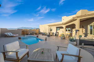 View of swimming pool with a mountain view, an outdoor living space, and a patio