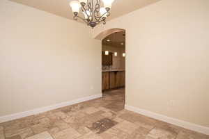 Spare room featuring a chandelier