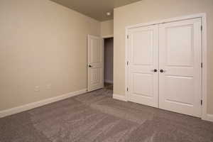 Unfurnished bedroom with carpet floors and a closet