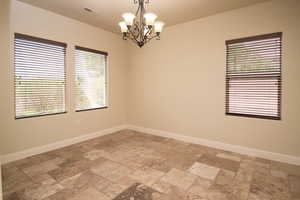 Empty room featuring a chandelier