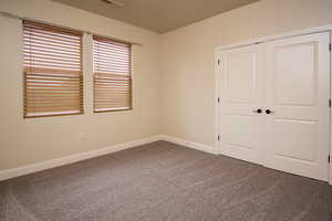 Unfurnished bedroom with carpet and a closet