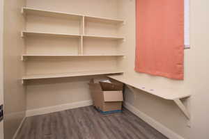 Unfurnished office featuring dark hardwood / wood-style flooring