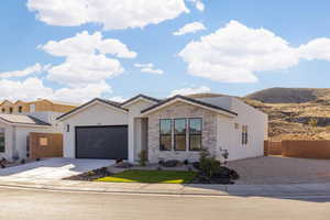 View of front of house with a mountain view and a garage