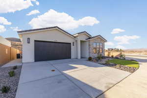 View of front of home featuring a garage and central AC unit